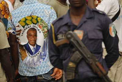 An policeman stands guard at a pro-Gbagbo rally in Abidjan (AP)